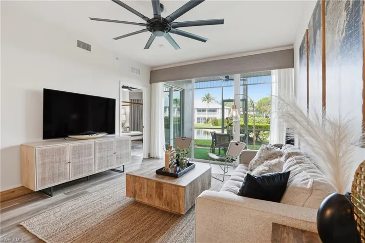 Living area with wood finished floors and a ceiling fan