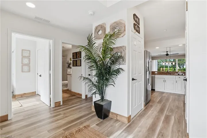Corridor with light wood finished floors and recessed lighting