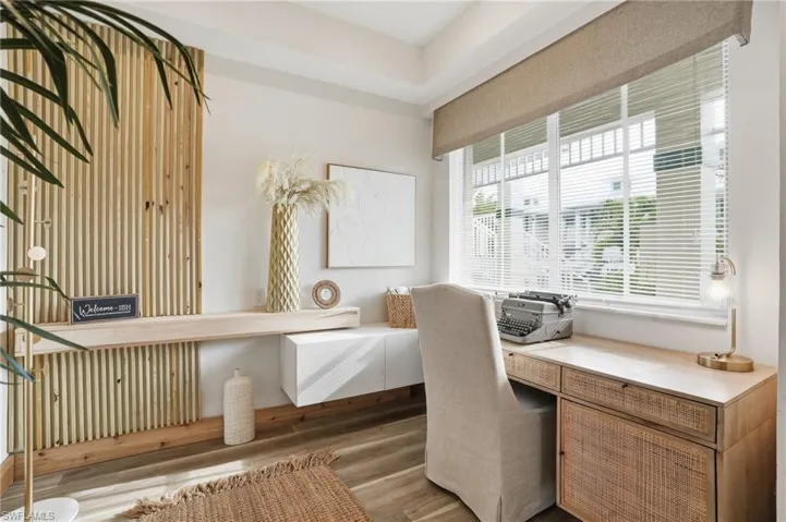 Office space with wood finished floors and built in desk