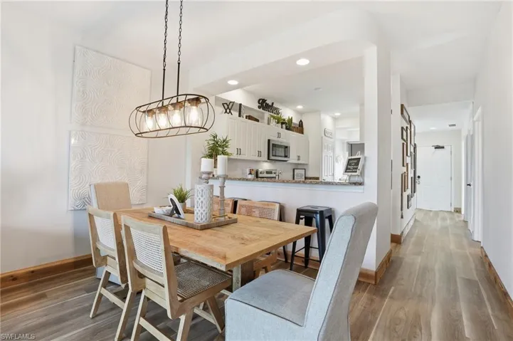 Dining room with wood finished floors and recessed lighting