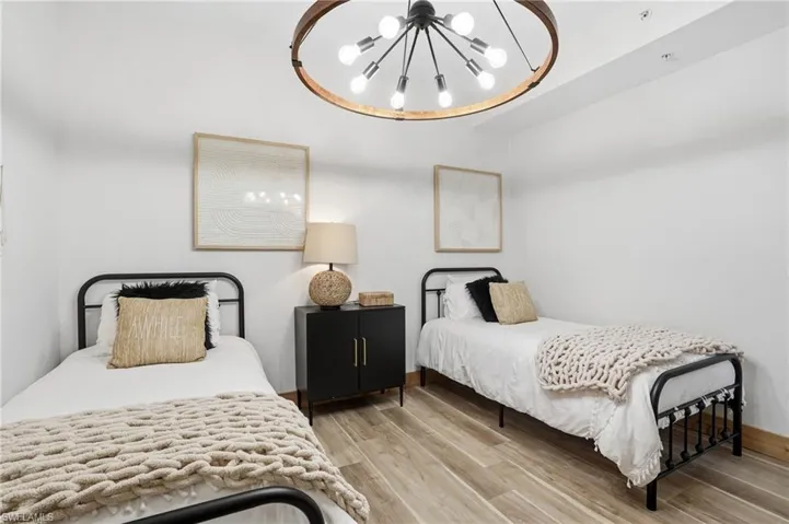 Bedroom featuring a chandelier and light wood-style floors