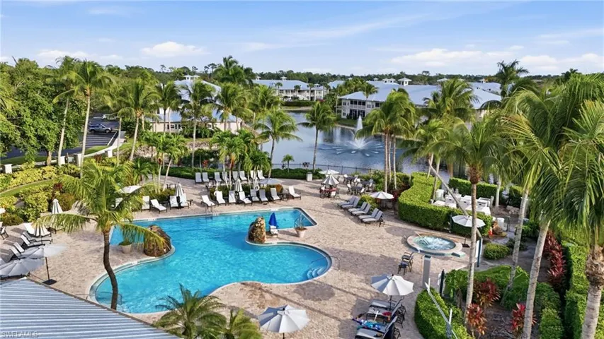Community pool with a water view, a patio, and a community hot tub