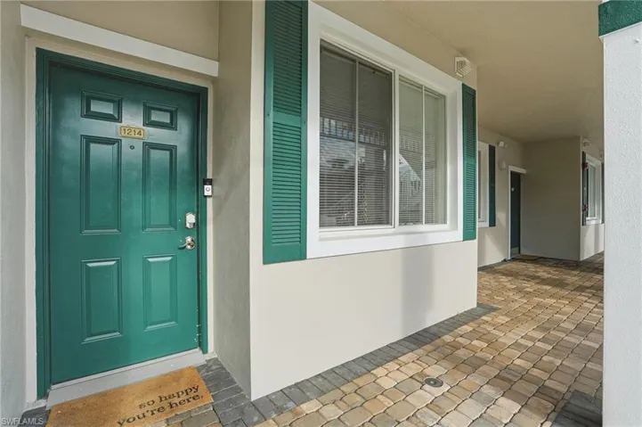 Doorway to property with stucco siding