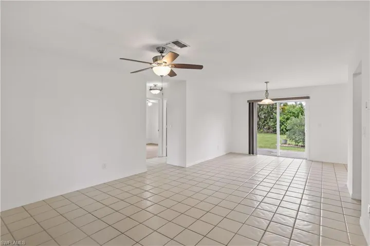 Spare room with light tile patterned floors and a ceiling fan