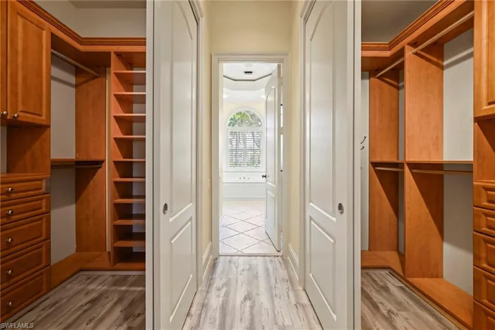 Spacious closet featuring light wood-type flooring