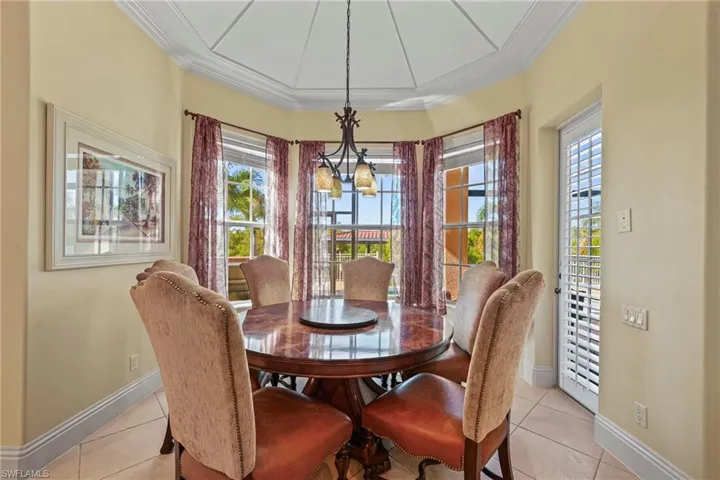Dining room featuring light tile patterned flooring and ornamental molding