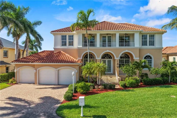 Mediterranean / spanish home with a balcony, stucco siding, decorative driveway, a front yard, and an attached garage
