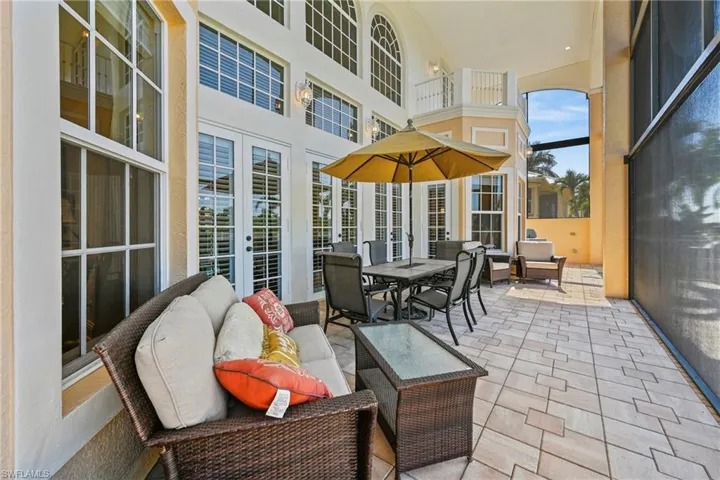 Sunroom with a towering ceiling and french doors