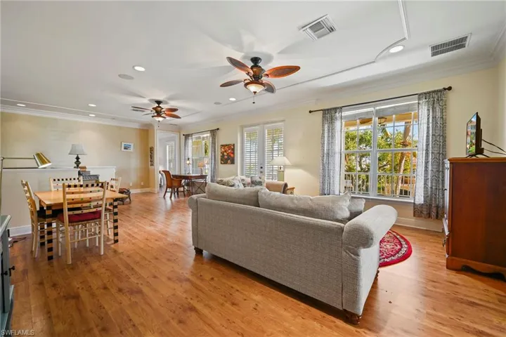 Living area featuring light wood-style floors, ornamental molding, recessed lighting, and ceiling fan