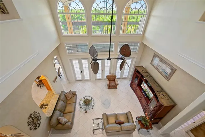 Living area featuring a towering ceiling and tile patterned flooring