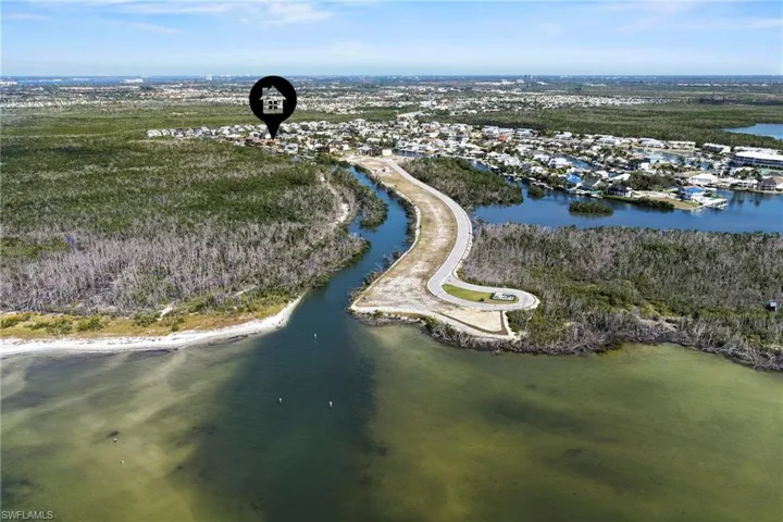 Aerial view of property and surrounding area featuring a nearby body of water