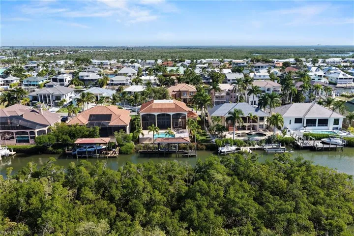 Aerial view of residential area featuring a large body of water