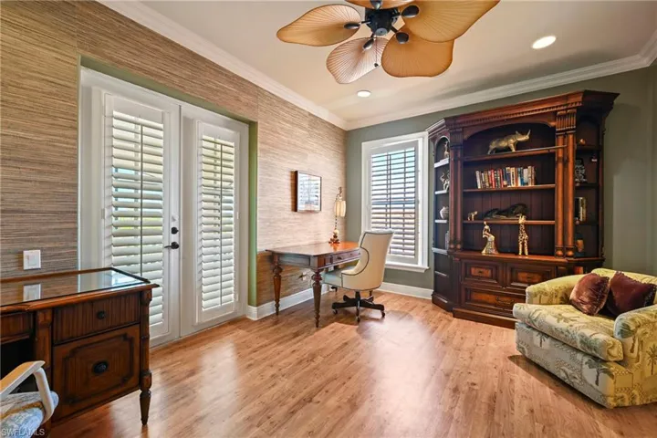 Office area with light wood-type flooring, ornamental molding, a ceiling fan, french doors, and recessed lighting