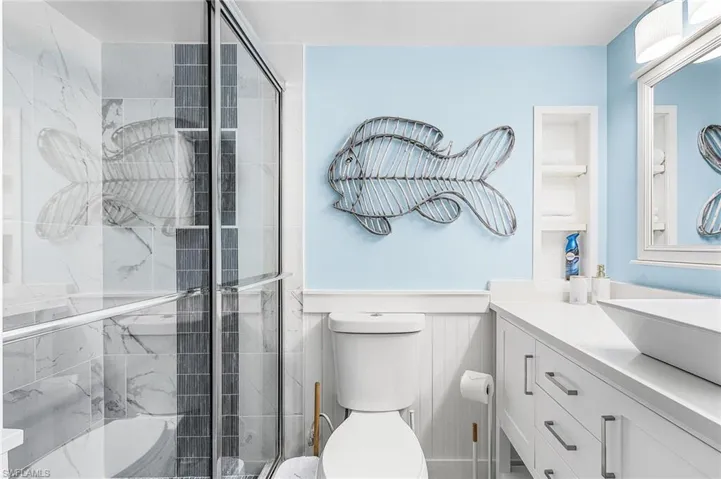 The downstairs bath with a shower also serves as the pool bath.