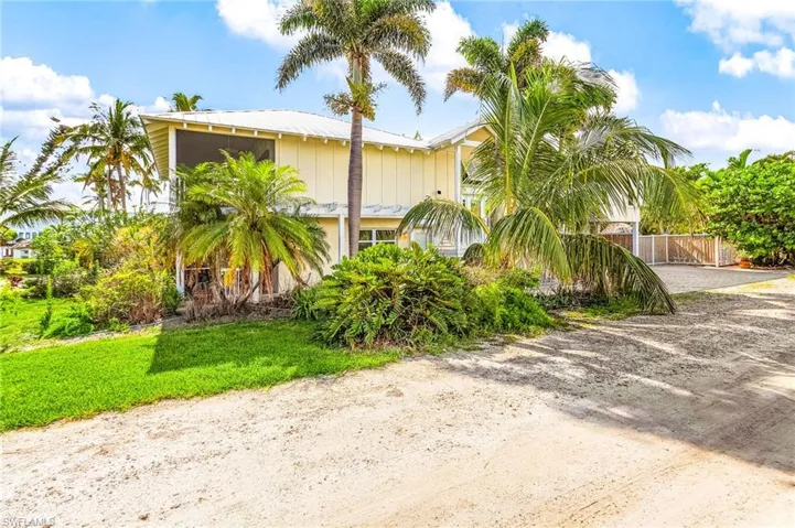 Lots of tropical vegetation around the home, with upper and lower level screen porches.