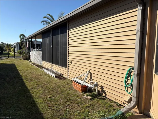 View of property exterior with a lawn