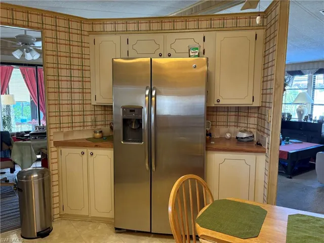 Kitchen featuring ceiling fan and stainless steel fridge