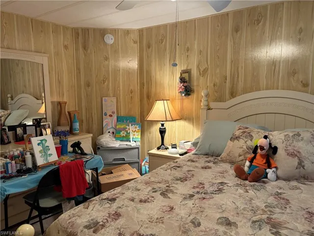 Bedroom featuring wood walls
