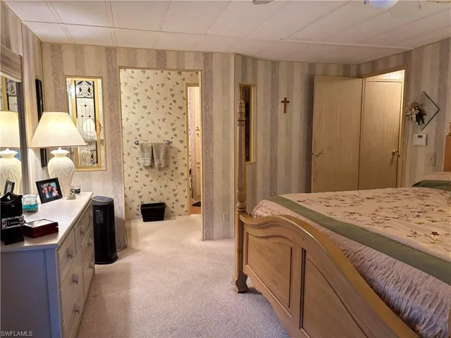 Bedroom with light carpet