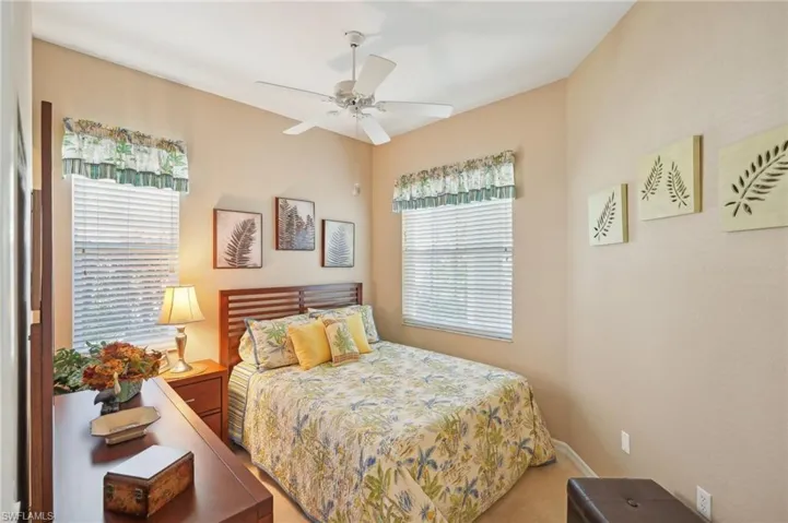 Bedroom with ceiling fan and carpet floors
