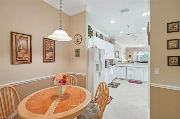 Dining area featuring visible vents, recessed lighting, a ceiling fan, and ornamental molding