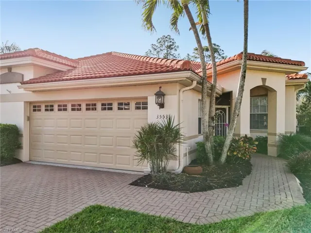 Mediterranean / spanish-style home featuring stucco siding, an attached garage, decorative driveway, and a tile roof