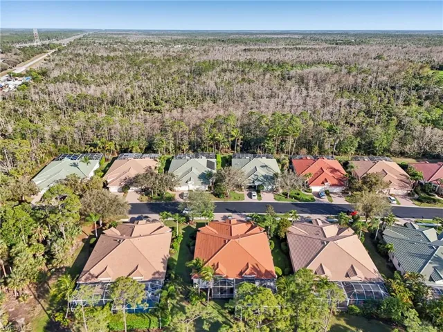 Drone / aerial view featuring a residential view and a wooded view
