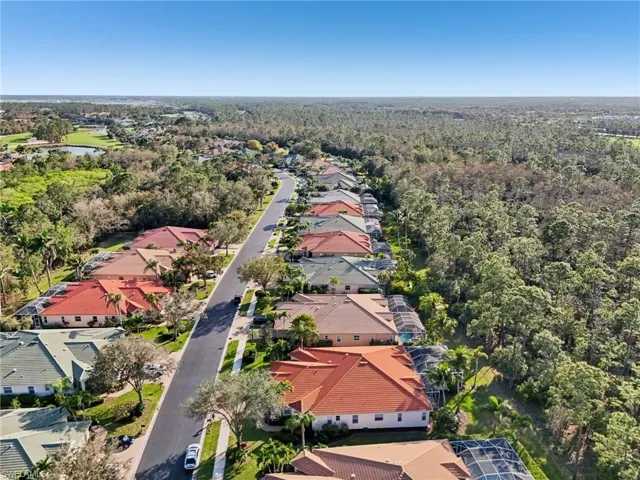 Birds eye view of property with a forest view and a residential view