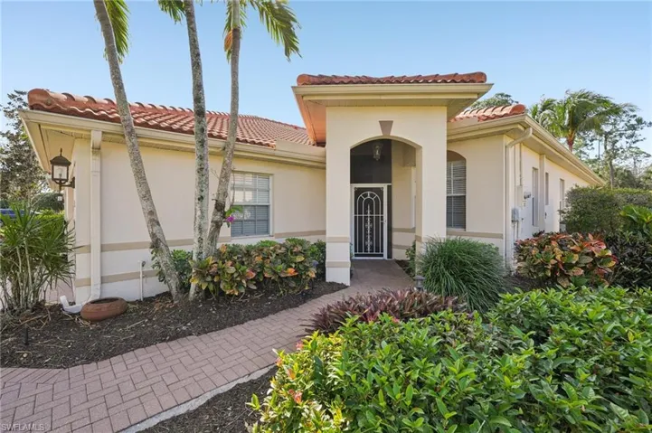 Mediterranean / spanish home with stucco siding and a tiled roof
