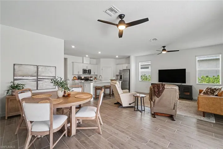 Open-concept interior featuring wood-finish flooring, recessed lighting, and ceiling fans