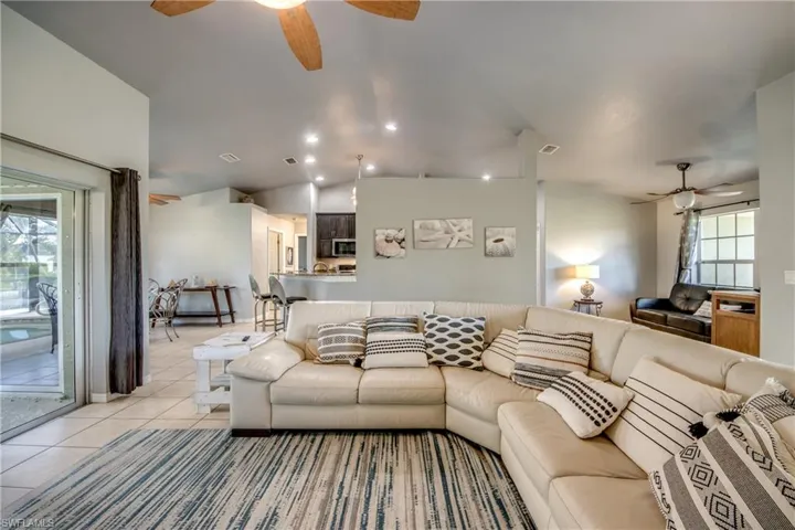 Single story home featuring french doors, a garage, stucco siding, concrete driveway, and a front lawn