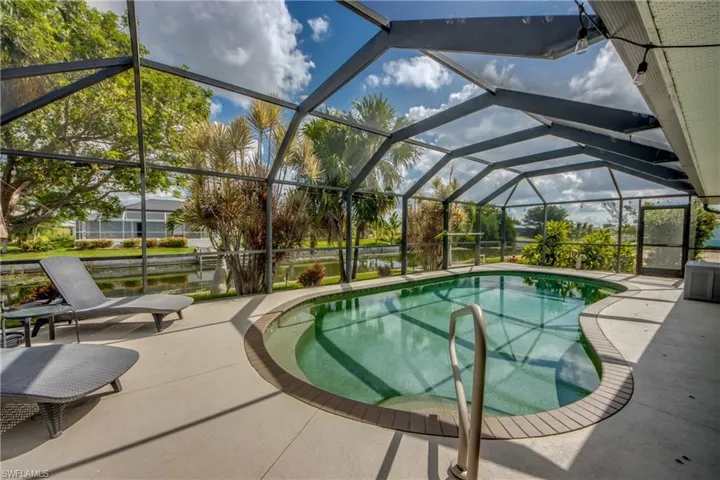 Outdoor pool featuring a patio, a lanai, and a ceiling fan