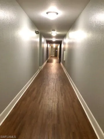Hallway featuring dark hardwood / wood-style floors