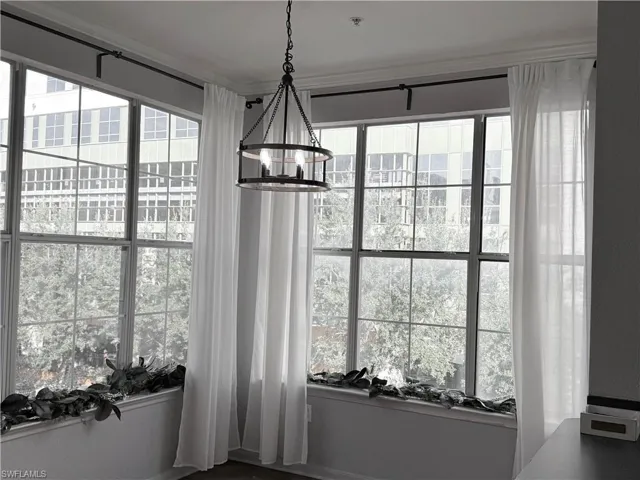 Dining area with crown molding and an inviting chandelier
