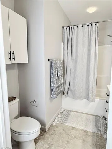 Full bathroom featuring shower / bath combo, toilet, and vanity