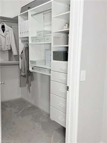 Spacious closet with carpet flooring