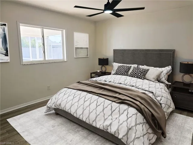 Bedroom with dark wood-style floors and ceiling fan