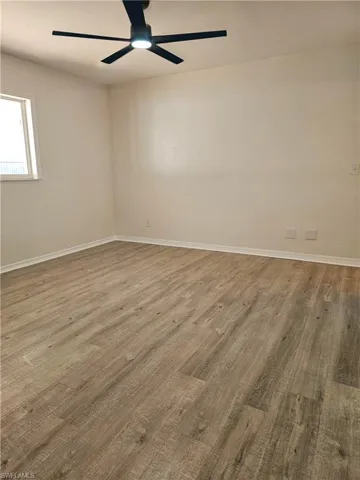 Unfurnished room featuring light wood-style flooring and ceiling fan