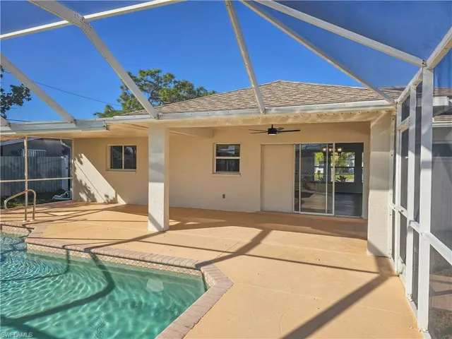 Swimming pool with glass enclosure and a patio area