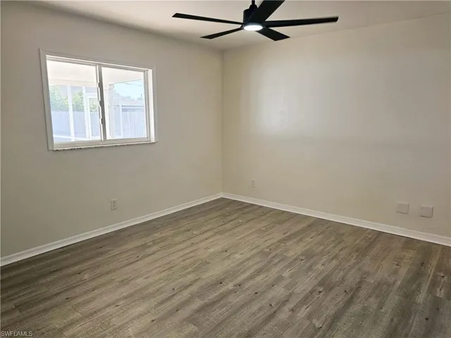 Empty room with wood finished floors and ceiling fan