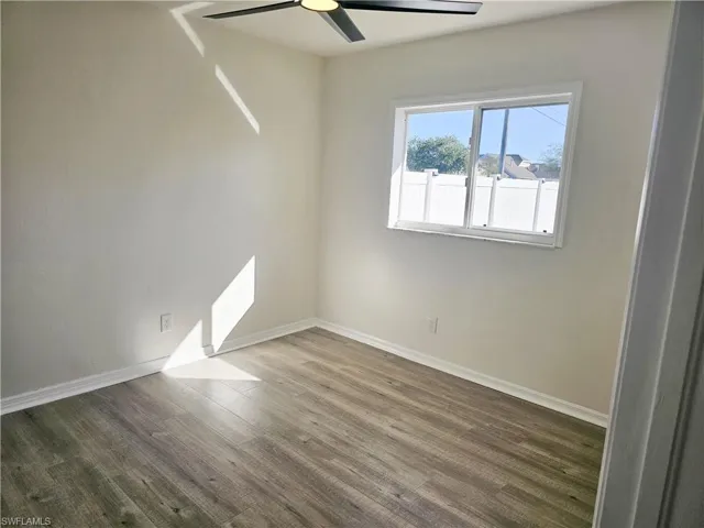 Empty room with wood finished floors and ceiling fan