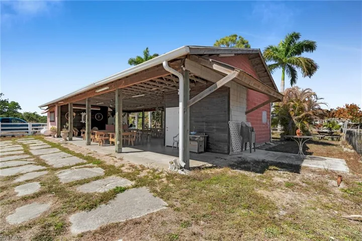 covered pavilion" "open-air barn" or "rustic reception hall".
