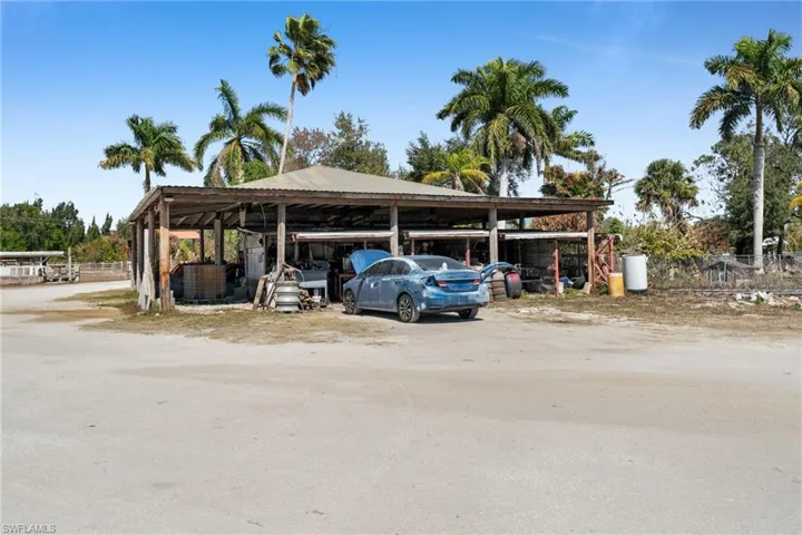 View of parking featuring a detached carport/ equipment storage