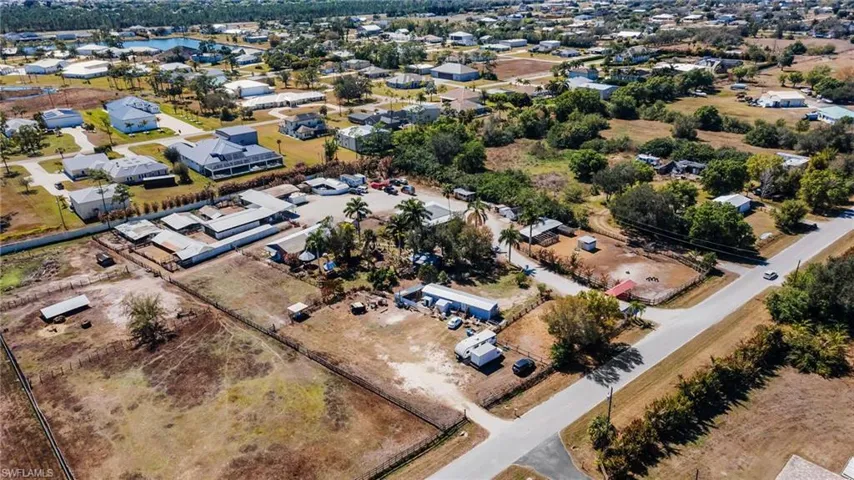 Aerial view of property's location with nearby suburban area