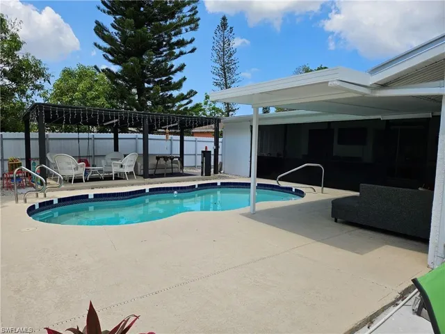 View of pool with a patio area and an outdoor hangout area