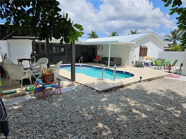 View of pool featuring an outdoor hangout area and a patio