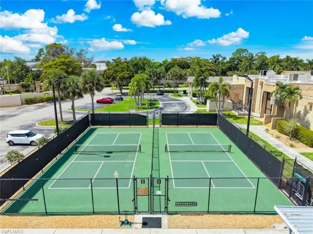 Pickleball courts featuring green surfacing and black perimeter fencing