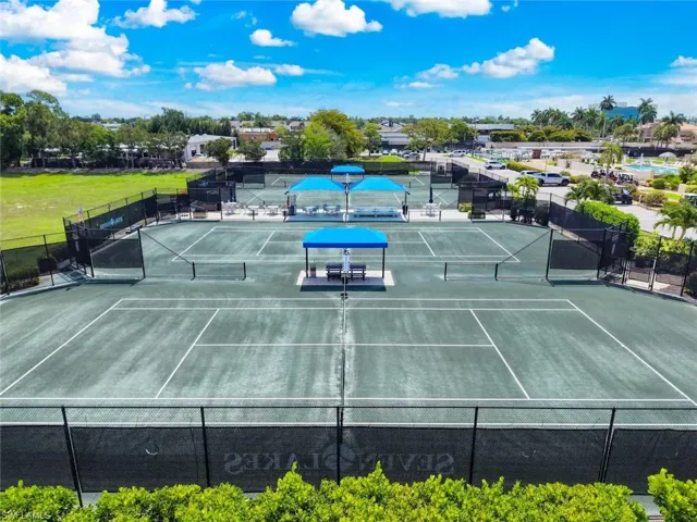 Multiple tennis courts featuring a hard court surface