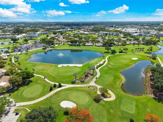 Aerial perspective showcasing a lush golf course with multiple greens, fairways, and sand traps