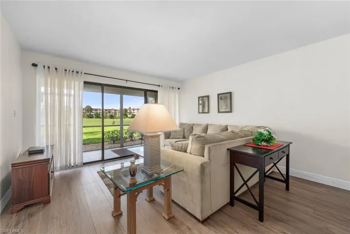 Bright interior living space featuring vinyl flooring and white walls